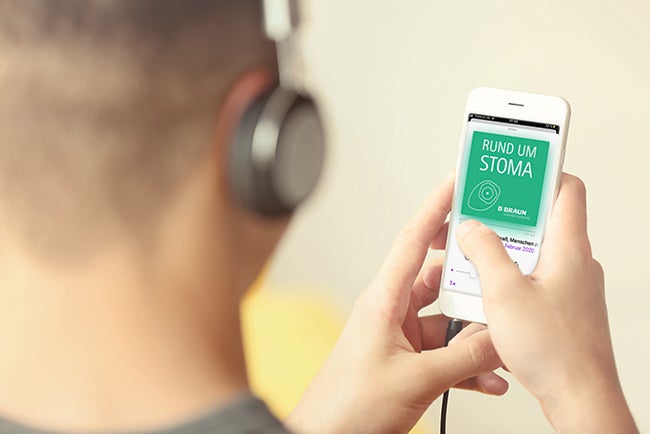 Young man listening to music on smartphone in the room